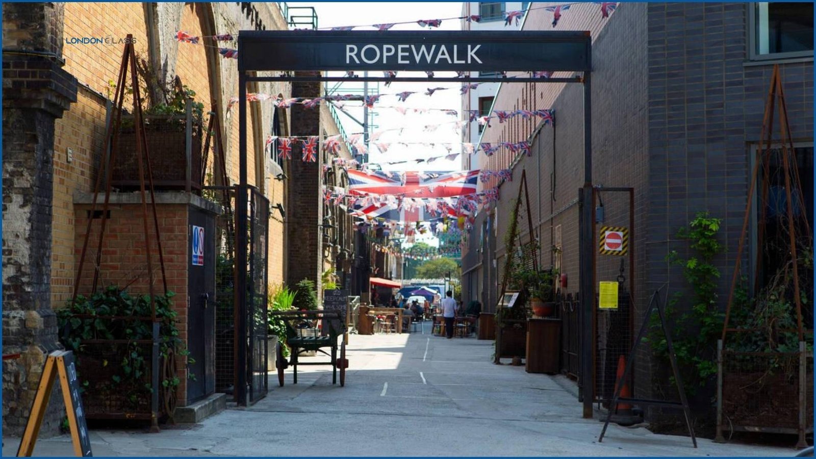 Ropewalk entrance at Maltby Street Market decorated with Union Jack flags