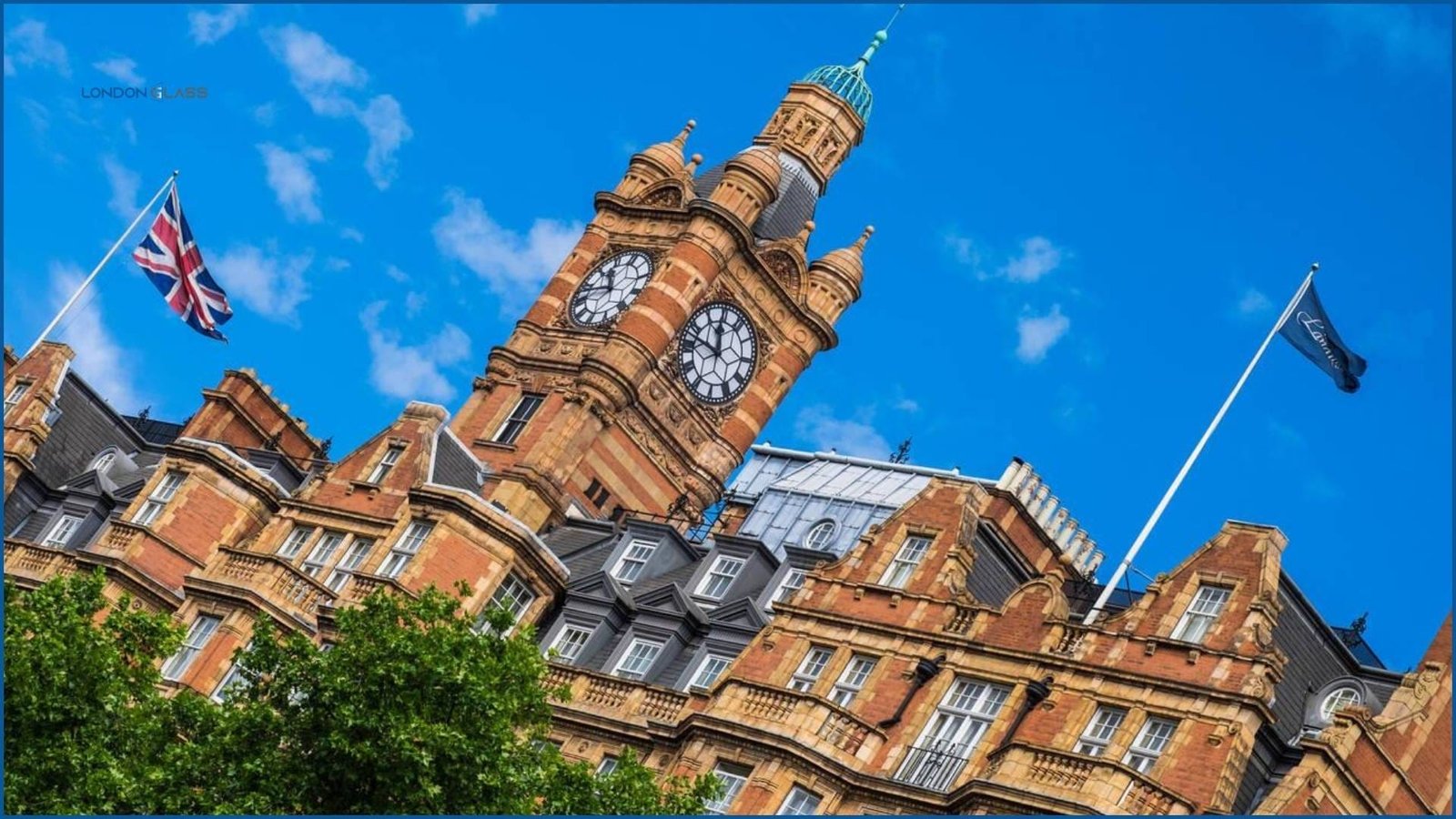 The Landmark London Hotel's iconic clock tower against a clear blue sky.