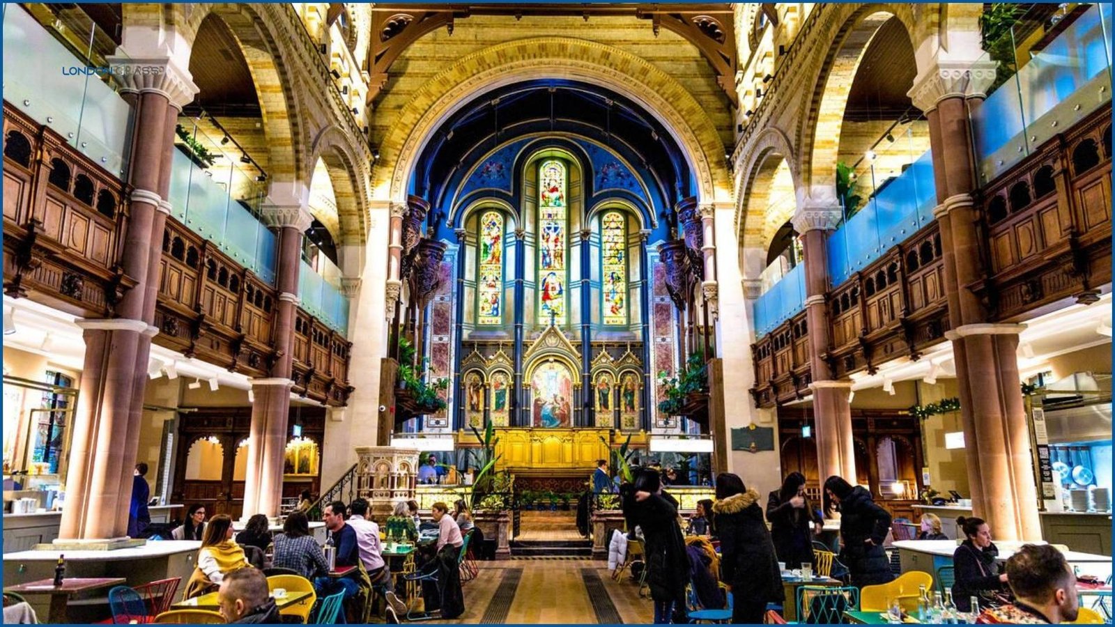 A beautifully decorated café interior at Church Street Market featuring stained glass windows and grand arches.