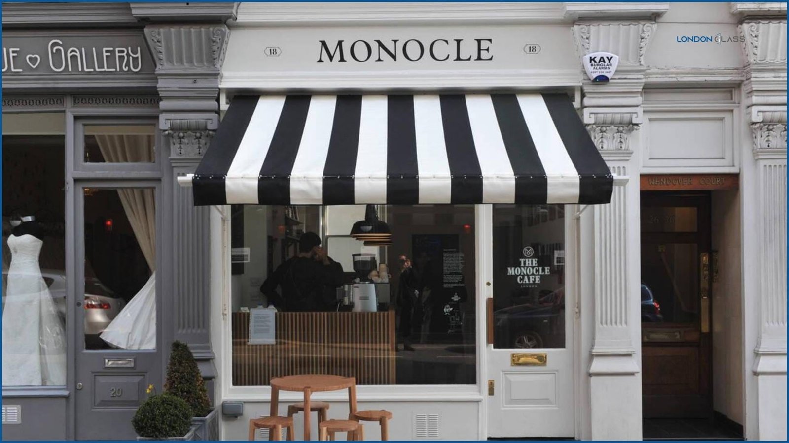 Monocle Café with a distinctive black and white striped awning in London.