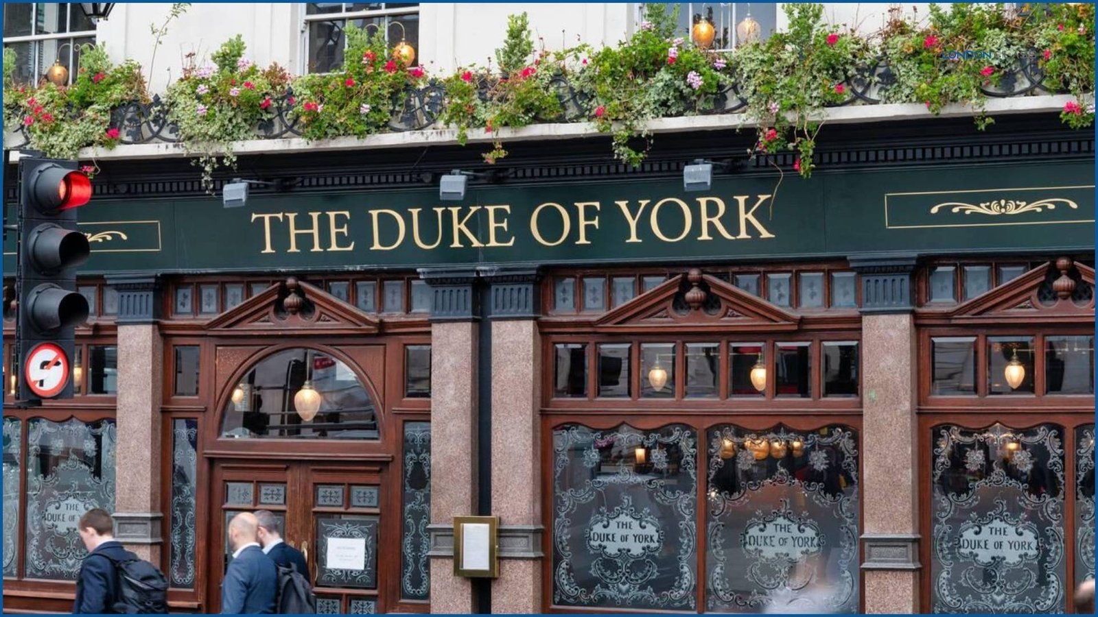 The Duke of York Pub in London with its classic facade and hanging flower baskets.