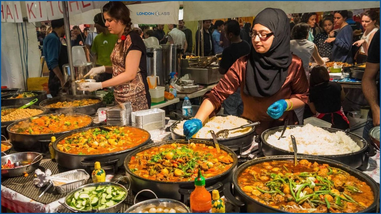 Food vendors serving a variety of vibrant and flavorful dishes at Brick Lane Market, London.