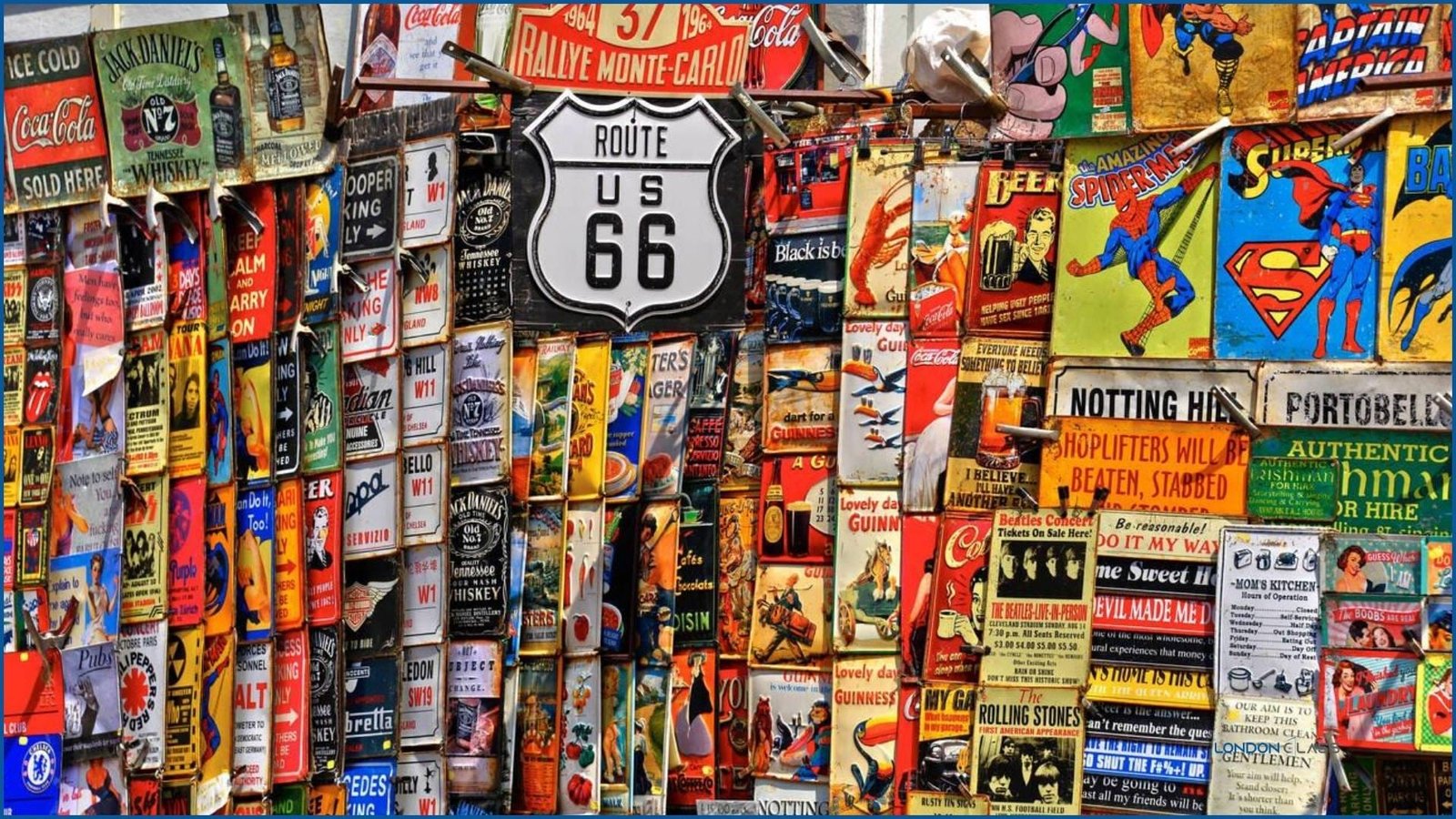 Colorful vintage and retro signs at a stall in Portobello Road Market, London.