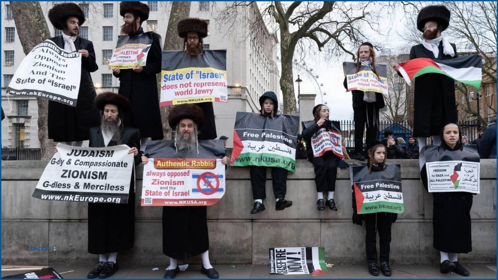 Hasidic Jewish men and children protesting with anti-Zionism signs in London