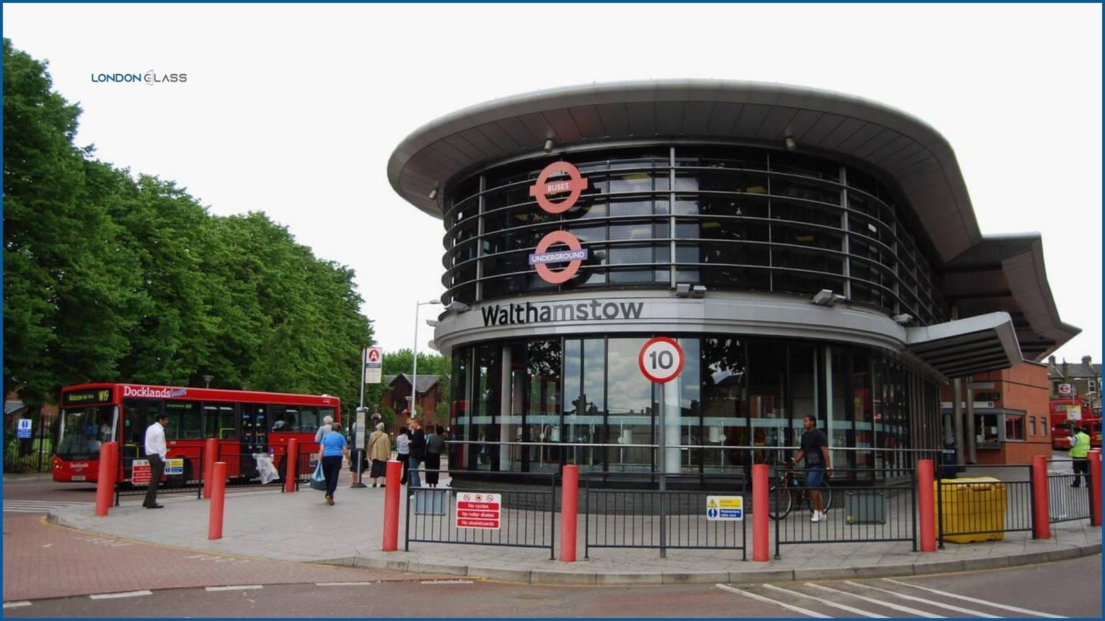 Walthamstow Central Tube Station with red buses parked outside.