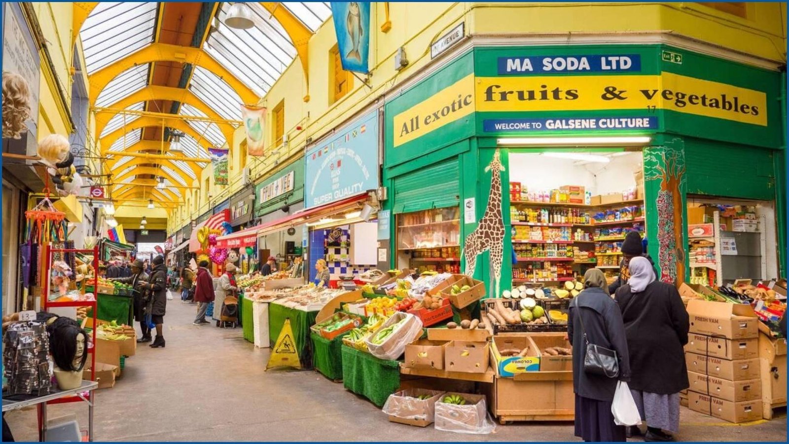 Inside Brixton Market with colorful stalls and shoppers