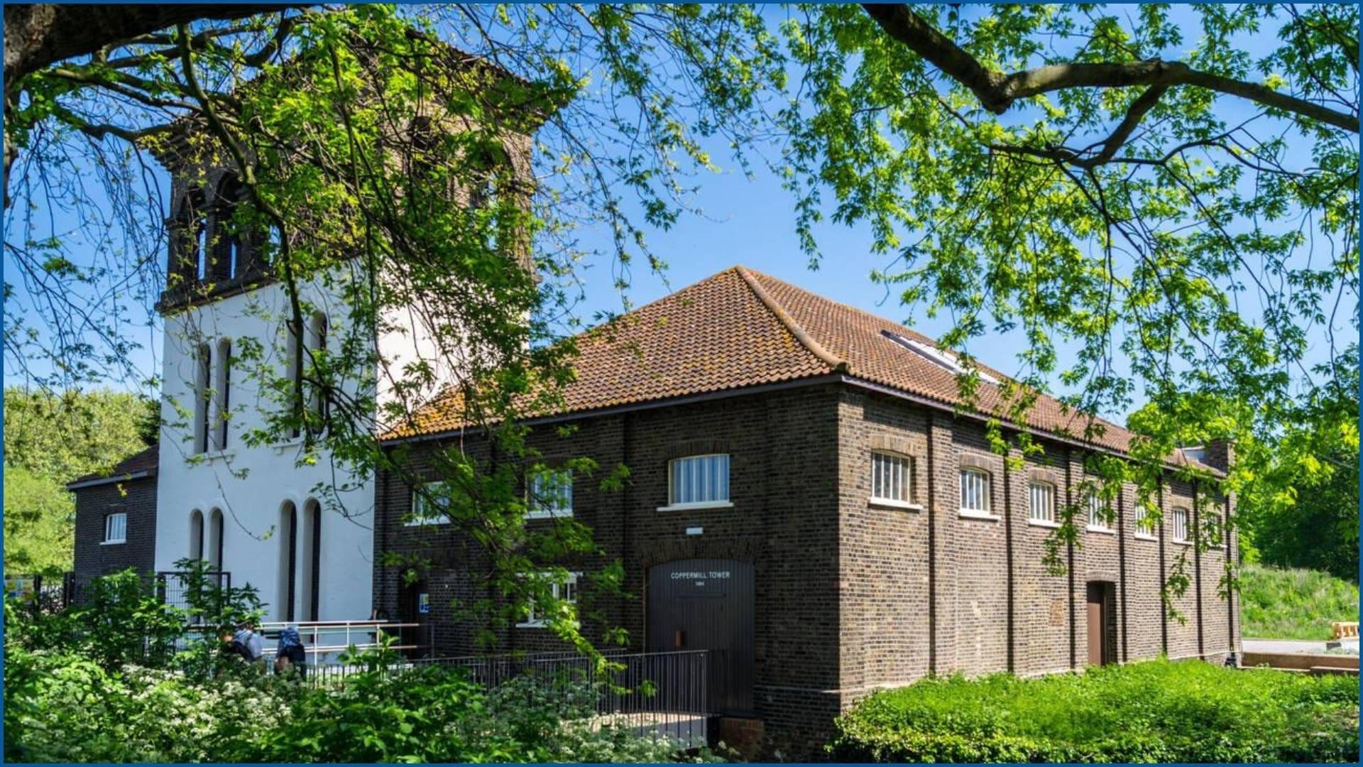 Coppermill Tower in Walthamstow surrounded by lush greenery on a sunny day