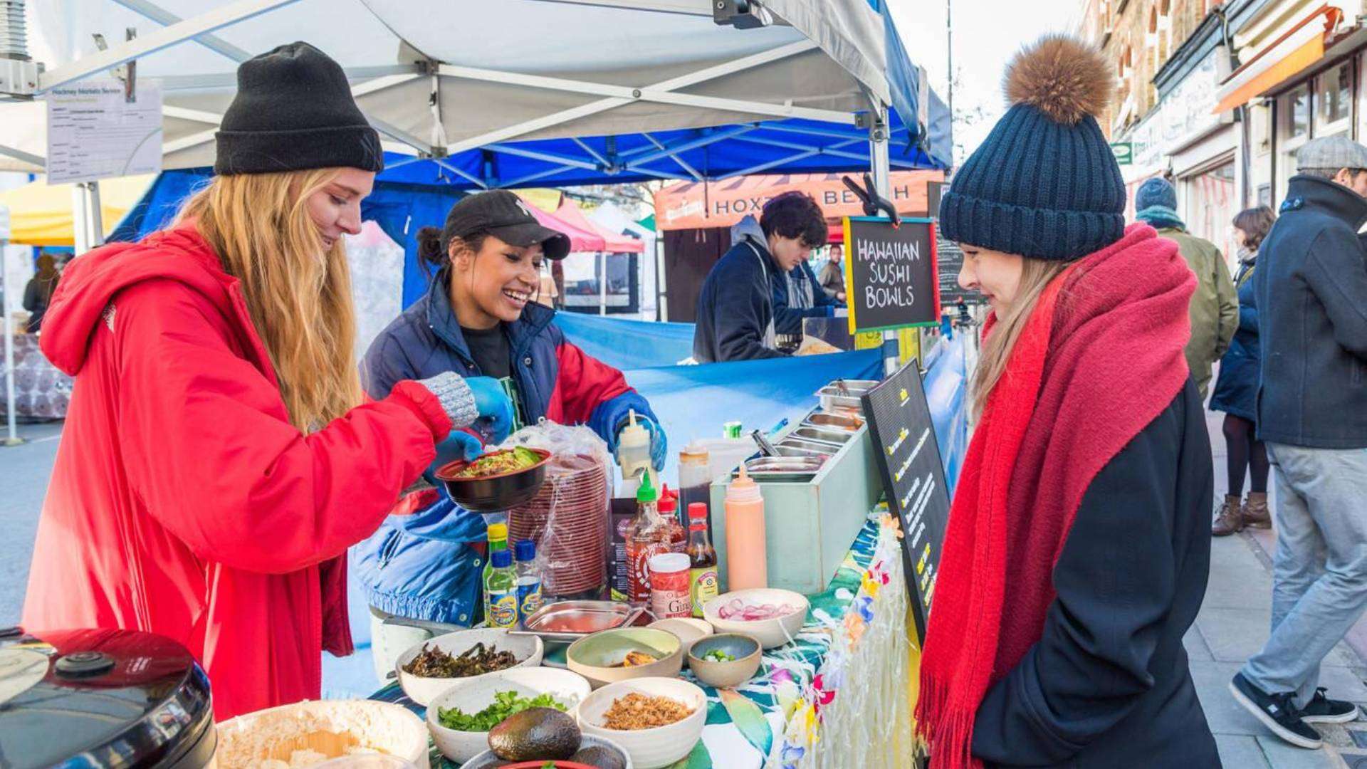 Vibrant food stall at Chatsworth Road Market with fresh ingredients and friendly vendors in Clapton Park, Hackney.