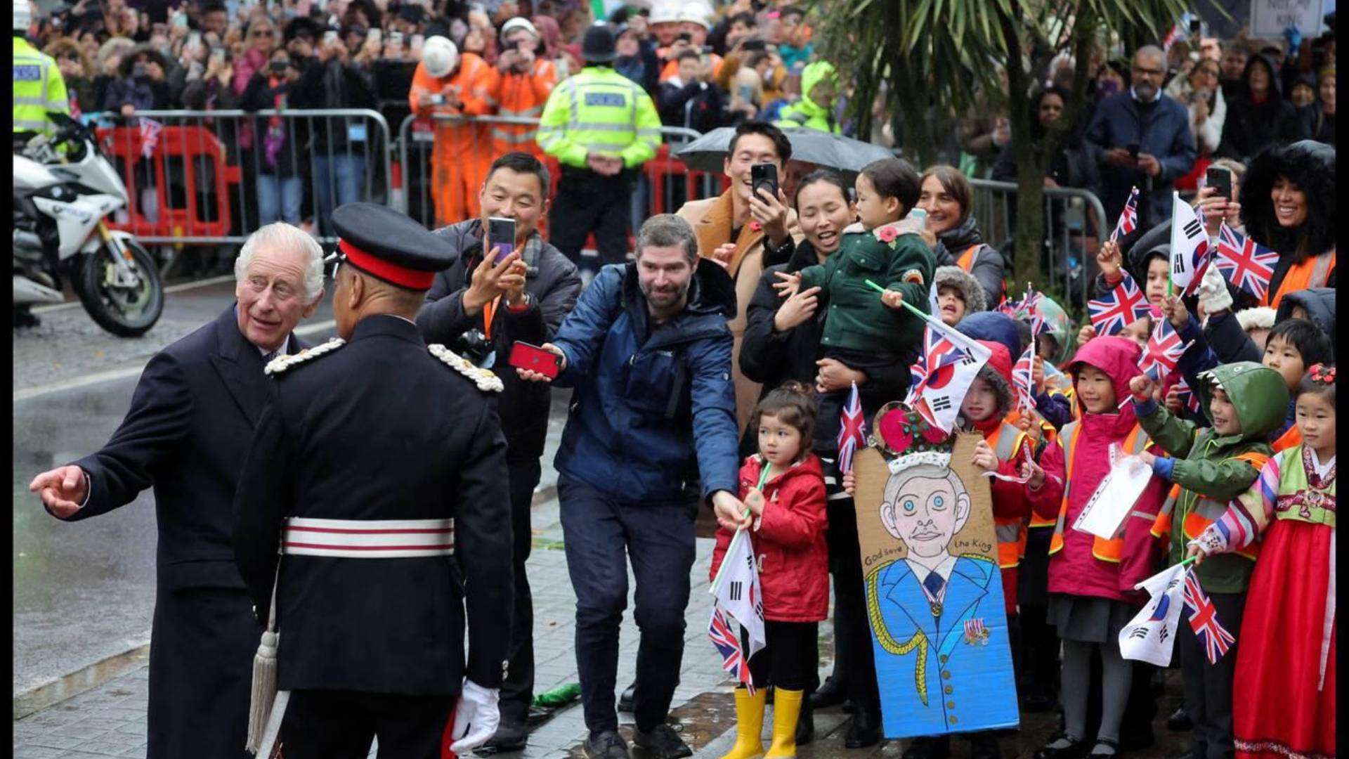 King Charles interacting with the Korean community during a visit to New Malden.