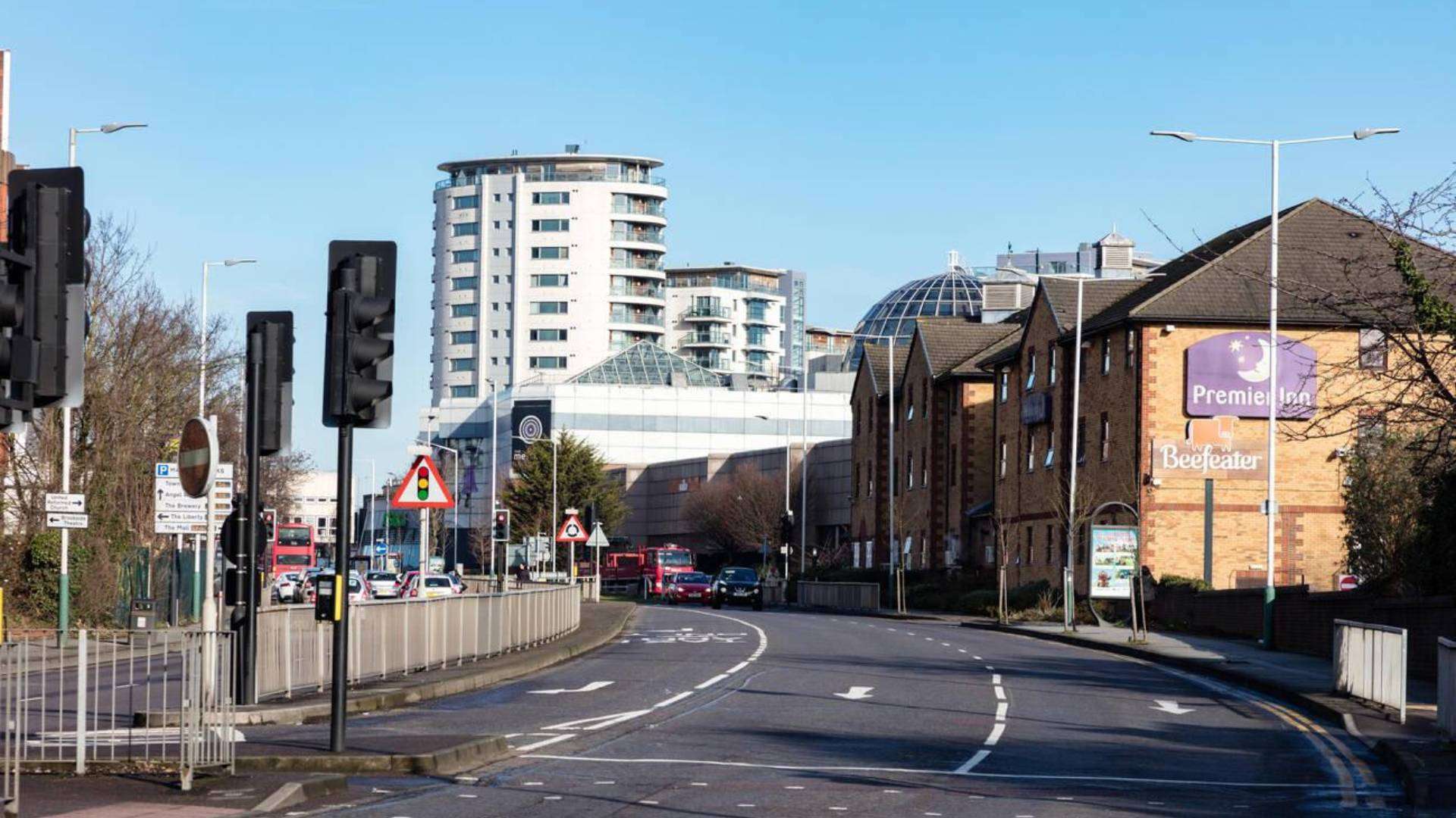 Chadwell Heath road with Premier Inn, Beefeater restaurant, and modern buildings.