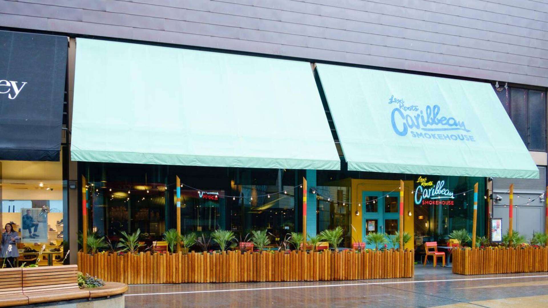 Levi Roots Caribbean Smokehouse exterior, with vibrant decor and outdoor seating.