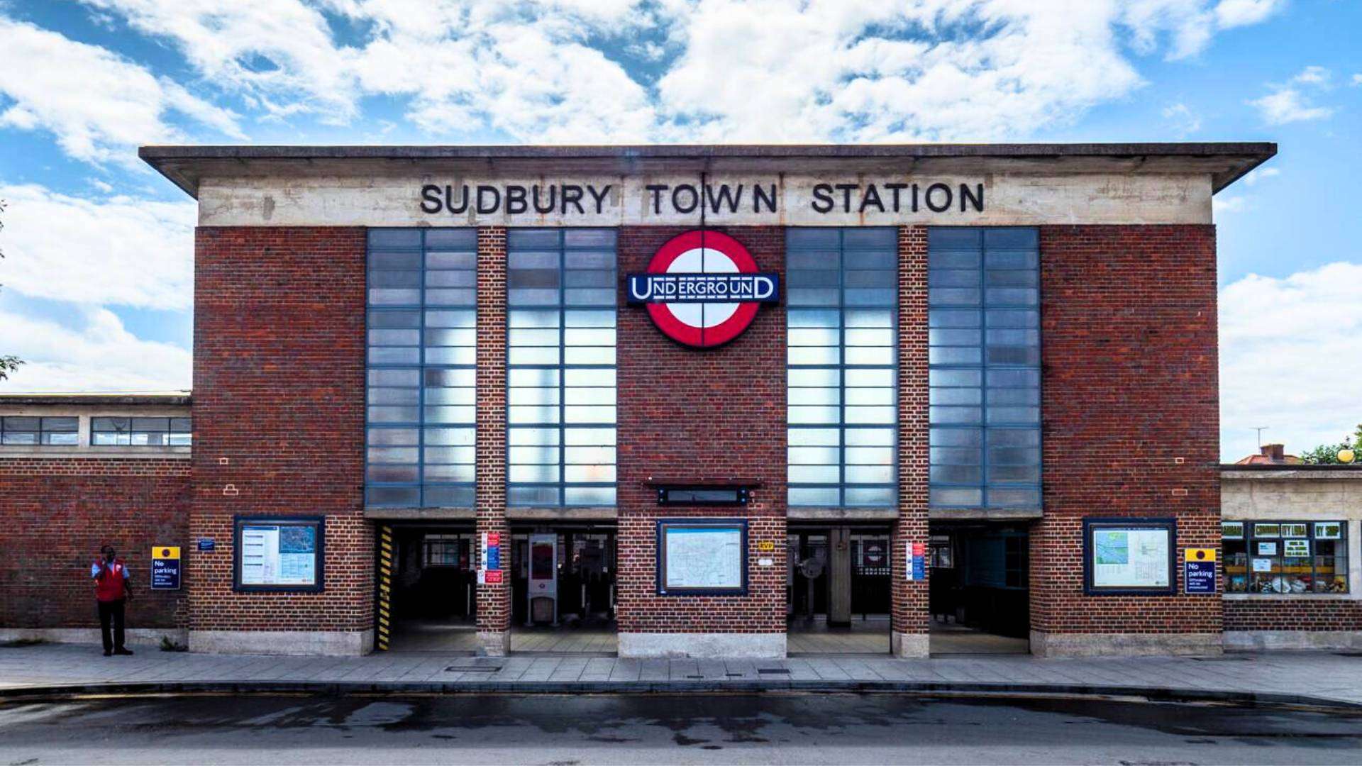Front view of Sudbury Town Station with its iconic red Underground sign.