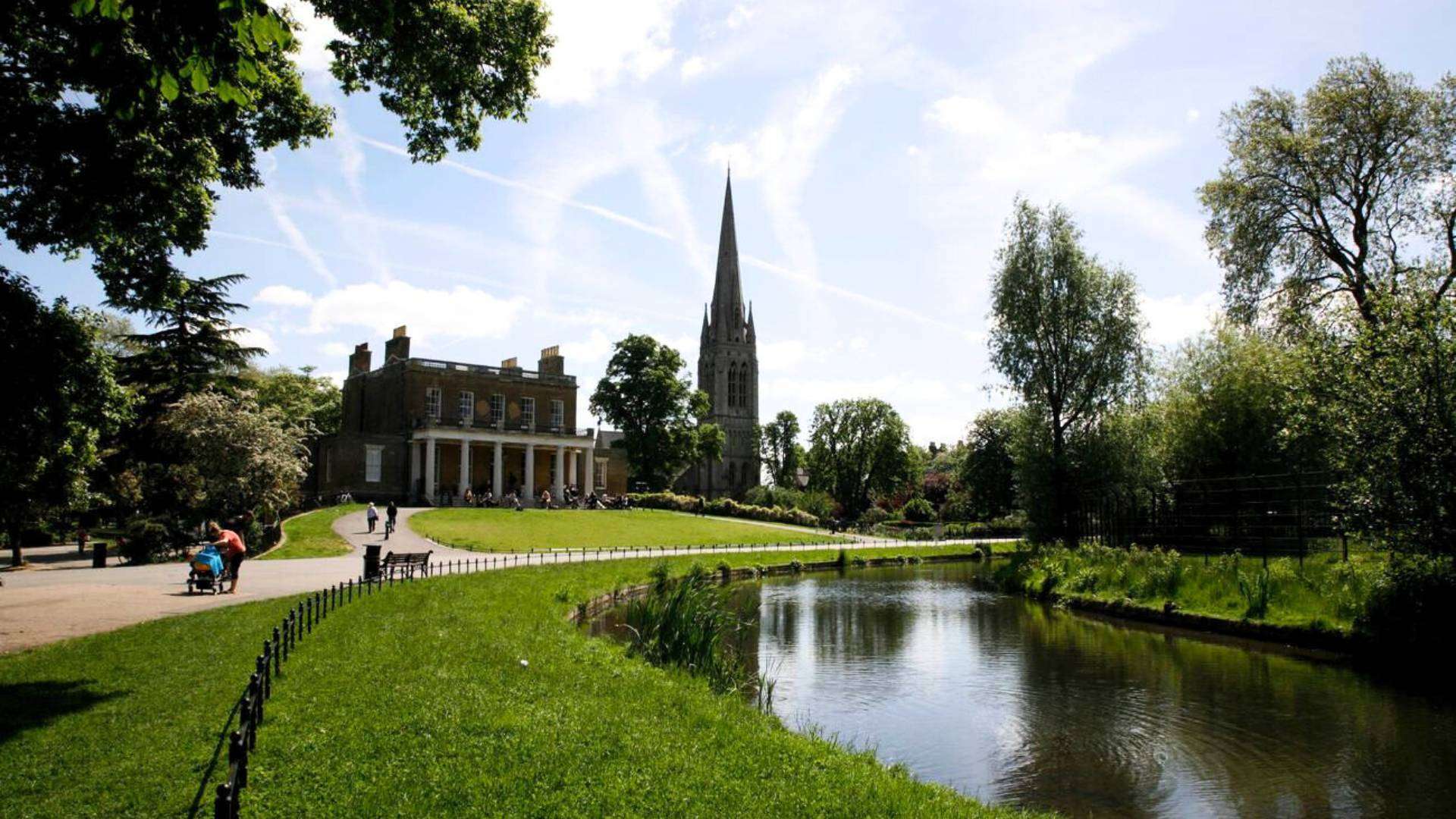 A scenic pond and historic building in Clissold Park, Stoke Newington.